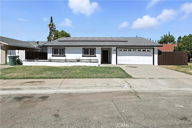 3537 Trinity Ct, Merced, CA 95340 - ranch-style home featuring an attached garage, stucco siding, concrete driveway, and solar panels
