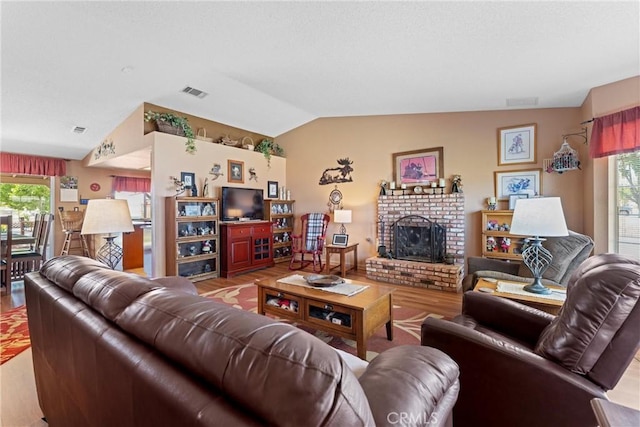 36916 95th St E, Littlerock, CA 93543 - living room with lofted ceiling, wood finished floors, and a brick fireplace