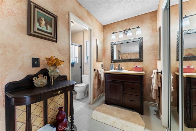 36916 95th St E, Littlerock, CA 93543 - bathroom featuring vanity, a stall shower, a textured ceiling, tile patterned floors, and a textured wall