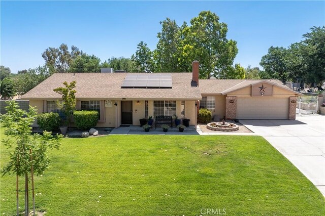 36916 95th St E, Littlerock, CA 93543 - single story home with roof mounted solar panels, a garage, concrete driveway, a chimney, and brick siding