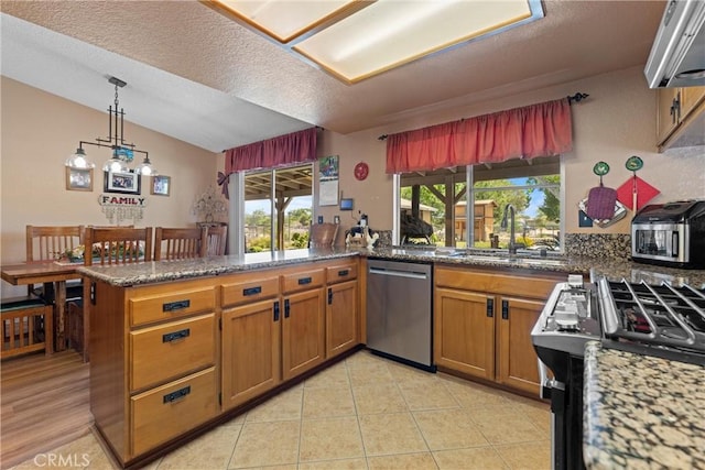 36916 95th St E, Littlerock, CA 93543 - kitchen featuring dishwasher, a peninsula, brown cabinetry, plenty of natural light, and a textured ceiling