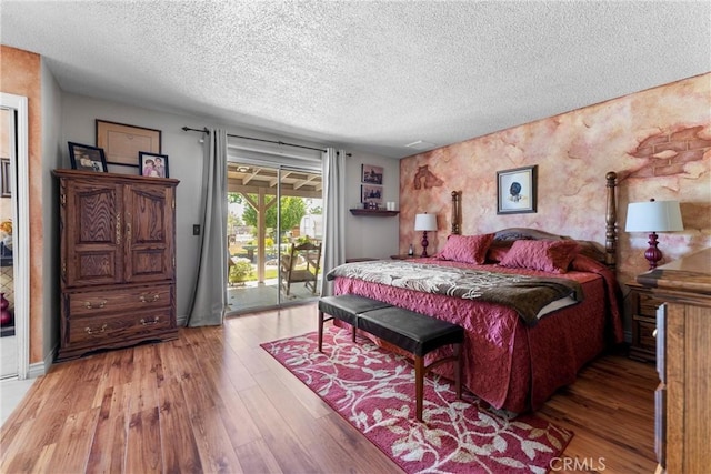 36916 95th St E, Littlerock, CA 93543 - bedroom with access to outside, a textured ceiling, and wood finished floors
