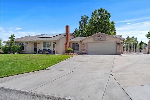 36916 95th St E, Littlerock, CA 93543 - single story home with a garage, driveway, solar panels, and brick siding