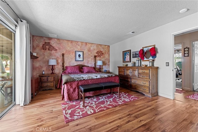 36916 95th St E, Littlerock, CA 93543 - bedroom featuring a textured ceiling, light wood finished floors, and access to exterior