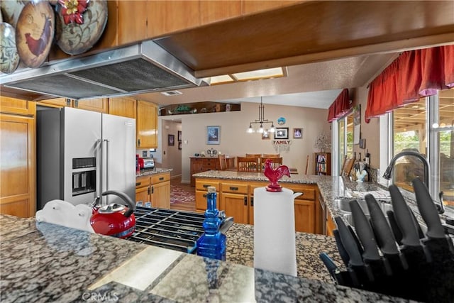 36916 95th St E, Littlerock, CA 93543 - kitchen featuring high end fridge, a chandelier, a peninsula, pendant lighting, and light stone counters