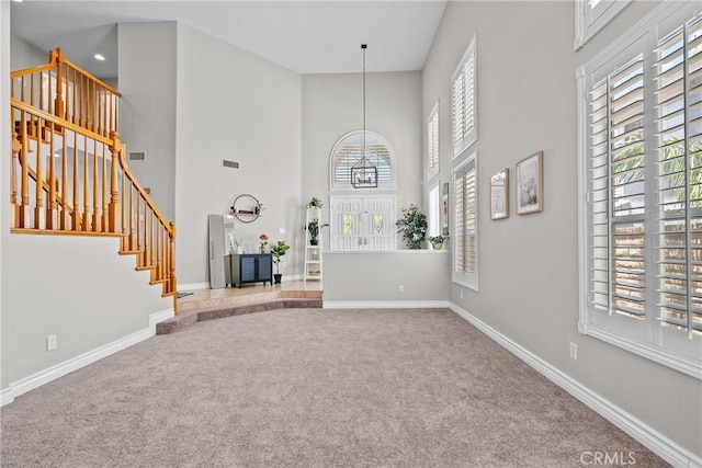 27318 Chesterfield Dr, Valencia, CA 91354 - carpeted foyer featuring stairway, a towering ceiling, plenty of natural light, and a chandelier