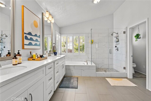 27318 Chesterfield Dr, Valencia, CA 91354 - bathroom with vaulted ceiling, a garden tub, a shower stall, double vanity, and tile patterned flooring