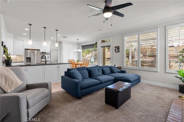 27318 Chesterfield Dr, Valencia, CA 91354 - living room with light carpet, ceiling fan, crown molding, recessed lighting, and a chandelier