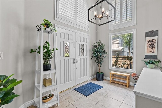 27318 Chesterfield Dr, Valencia, CA 91354 - foyer entrance with a chandelier, light tile patterned flooring, and a high ceiling