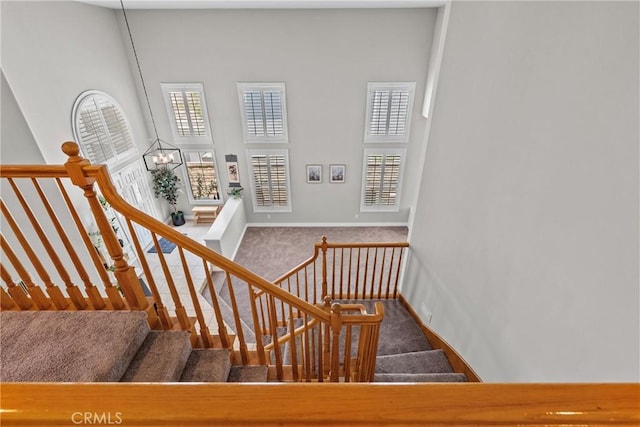 27318 Chesterfield Dr, Valencia, CA 91354 - stairway featuring carpet flooring, a high ceiling, and a chandelier