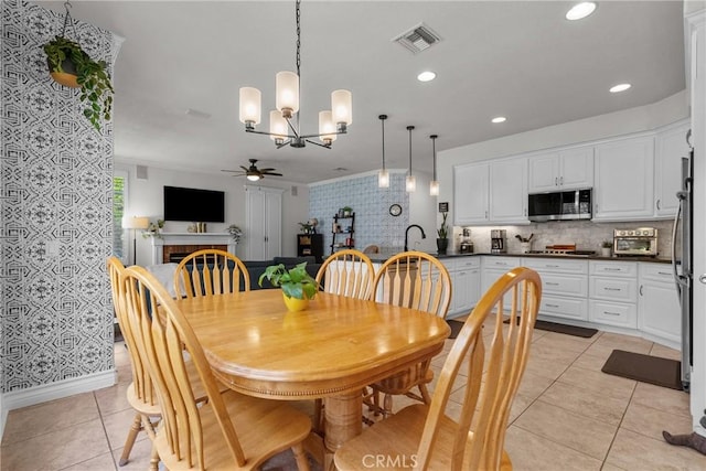 27318 Chesterfield Dr, Valencia, CA 91354 - dining room with ceiling fan, light tile patterned floors, a chandelier, a fireplace, and recessed lighting