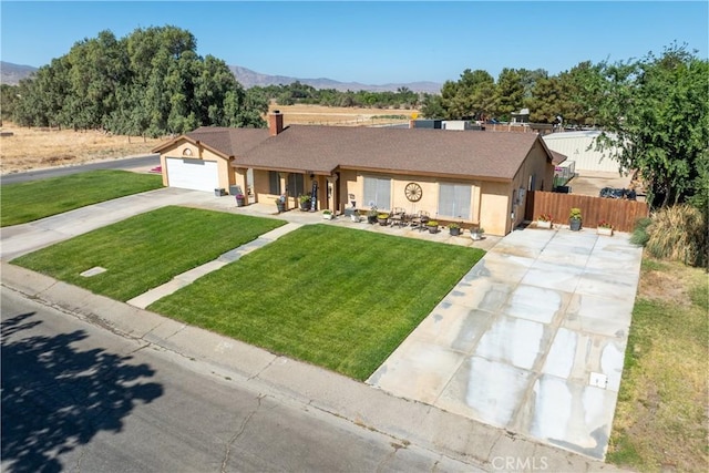 36807 95th St E, Littlerock, CA 93543 - single story home featuring concrete driveway, a mountain view, stucco siding, and a chimney