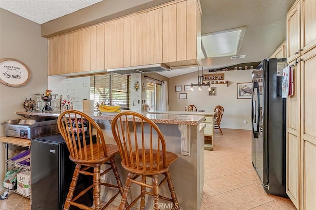 36807 95th St E, Littlerock, CA 93543 - kitchen featuring freestanding refrigerator, a breakfast bar, light tile patterned floors, a peninsula, and light brown cabinetry