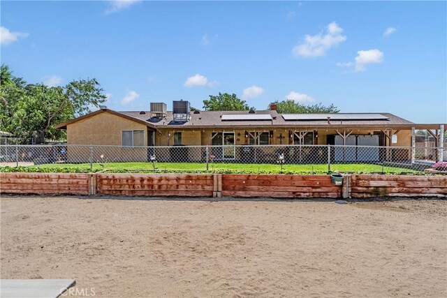 36807 95th St E, Littlerock, CA 93543 - view of front facade featuring roof mounted solar panels, a fenced front yard, and a chimney