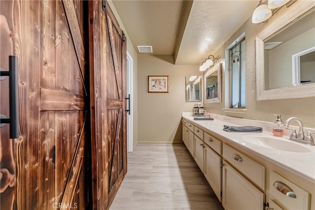 36807 95th St E, Littlerock, CA 93543 - bathroom featuring double vanity and wood finished floors