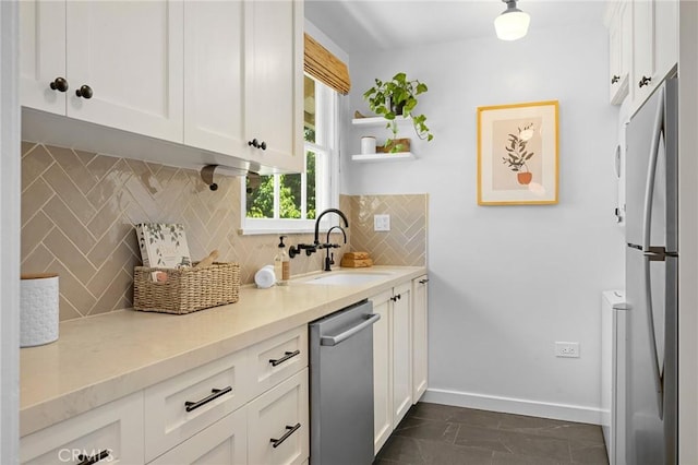 537 E Maple St Unit 3, Glendale, CA 91205 - kitchen with stainless steel dishwasher, freestanding refrigerator, white cabinetry, and backsplash