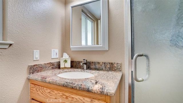 6200 Fairlynn Blvd, Yorba Linda, CA 92886 - bathroom with vanity, a textured wall, and a shower with door