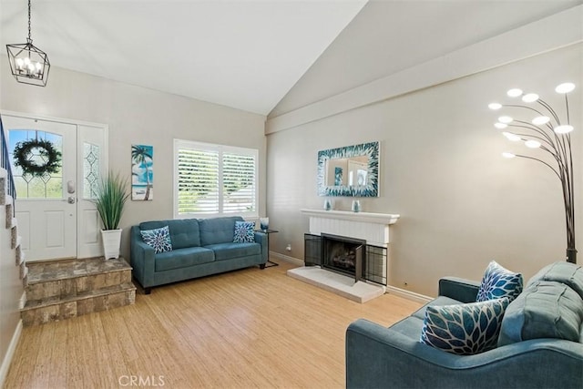 6200 Fairlynn Blvd, Yorba Linda, CA 92886 - living area with a chandelier, a fireplace with raised hearth, light wood finished floors, and high vaulted ceiling