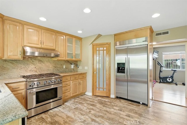 6200 Fairlynn Blvd, Yorba Linda, CA 92886 - kitchen featuring high quality appliances, under cabinet range hood, light wood-type flooring, decorative backsplash, and recessed lighting