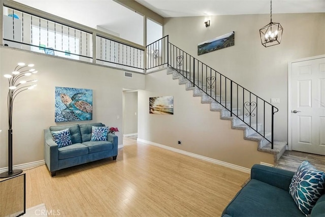 6200 Fairlynn Blvd, Yorba Linda, CA 92886 - living room with a chandelier, high vaulted ceiling, wood finished floors, and stairway