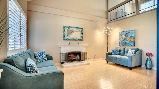6200 Fairlynn Blvd, Yorba Linda, CA 92886 - living room with a glass covered fireplace, wood finished floors, and a towering ceiling