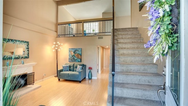 6200 Fairlynn Blvd, Yorba Linda, CA 92886 - stairs with wood finished floors, a high ceiling, and a tile fireplace