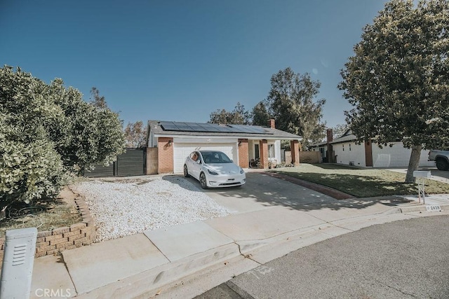 2438 Emerson Cir, Corona, CA 92882 - view of front of property featuring driveway, solar panels, brick siding, a garage, and a front yard