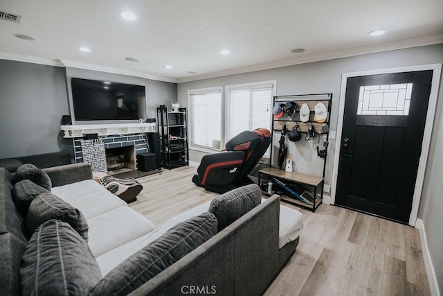 2438 Emerson Cir, Corona, CA 92882 - living room with light wood finished floors, recessed lighting, ornamental molding, and a fireplace