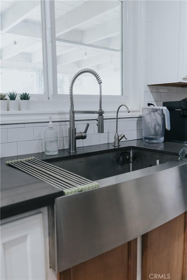 2438 Emerson Cir, Corona, CA 92882 - kitchen view of tasteful backsplash, dark countertops, and white cabinetry