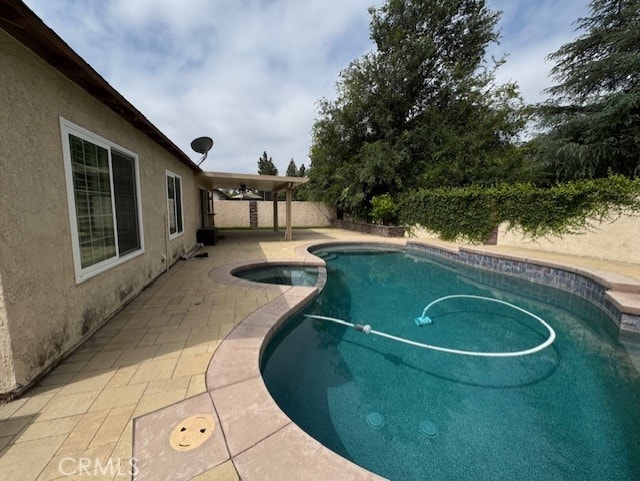 8641 Limestone Dr, Riverside, CA 92504 - view of pool with a patio, a pool with connected hot tub, and a fenced backyard