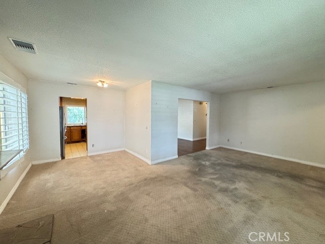 8641 Limestone Dr, Riverside, CA 92504 - empty room featuring a textured ceiling and carpet