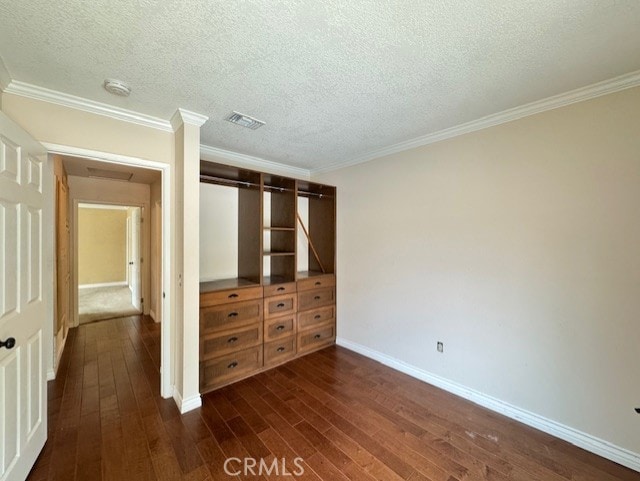 8641 Limestone Dr, Riverside, CA 92504 - unfurnished bedroom featuring dark wood finished floors, a textured ceiling, crown molding, and a closet