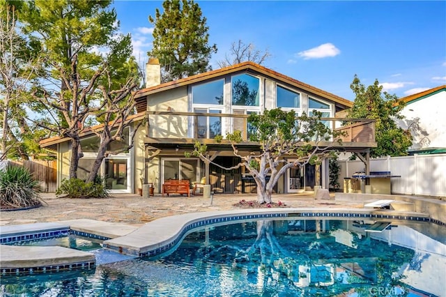 23216 Park Esperanza, Calabasas, CA 91302 - rear view of house with a patio, a balcony, a chimney, and a pool with connected hot tub