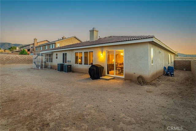 42432 72nd St W, Lancaster, CA 93536 - back of house with a chimney, stucco siding, a fenced backyard, and a tile roof