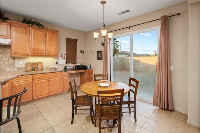 42432 72nd St W, Lancaster, CA 93536 - dining space with light tile patterned floors and a chandelier
