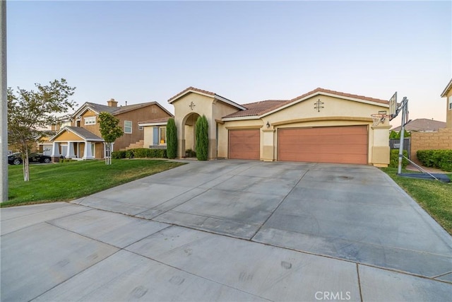 42432 72nd St W, Lancaster, CA 93536 - mediterranean / spanish house featuring stucco siding, driveway, a garage, a front lawn, and a tile roof