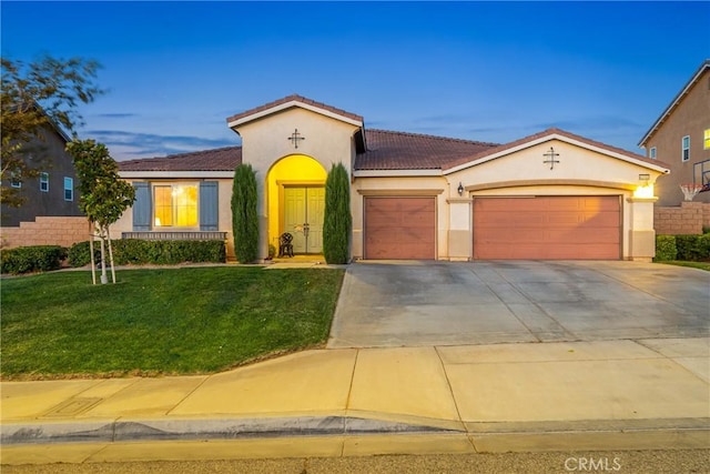 42432 72nd St W, Lancaster, CA 93536 - mediterranean / spanish house with a garage, stucco siding, a tiled roof, a front lawn, and driveway