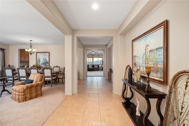 42432 72nd St W, Lancaster, CA 93536 - corridor with a chandelier, light tile patterned flooring, and light carpet