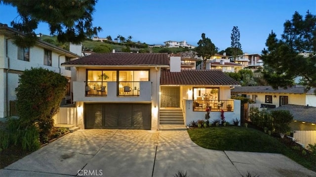 1716 Via Zurita, Palos Verdes Estates, CA 90274 - tri-level home featuring a balcony, stucco siding, an attached garage, driveway, and a tile roof