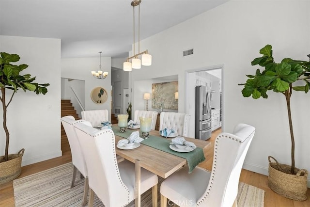 1716 Via Zurita, Palos Verdes Estates, CA 90274 - dining room featuring light wood-style floors, stairs, vaulted ceiling, and a chandelier