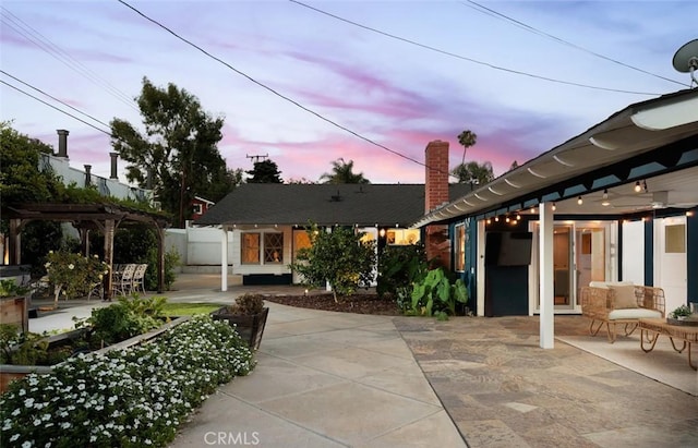 2119 E Denise Ave, Orange, CA 92867 - back of house at dusk with a patio area, a pergola, and a chimney