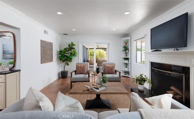 2119 E Denise Ave, Orange, CA 92867 - living area with wood finished floors, crown molding, a fireplace, recessed lighting, and a textured ceiling