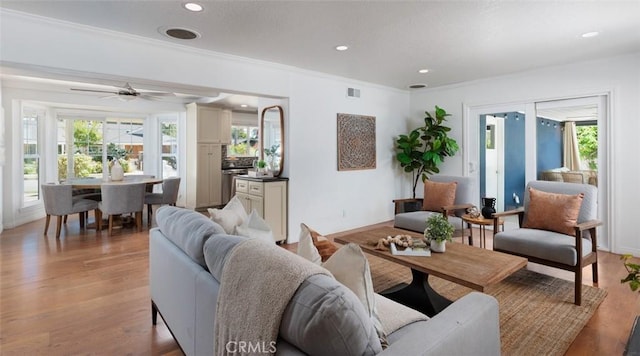 2119 E Denise Ave, Orange, CA 92867 - living room with plenty of natural light, light wood finished floors, ornamental molding, recessed lighting, and ceiling fan