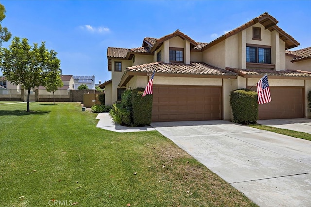 990 La Paz Rd Unit 49, Placentia, CA 92870 - mediterranean / spanish house with stucco siding, concrete driveway, a front lawn, a garage, and a tiled roof