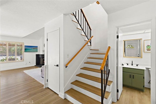 990 La Paz Rd Unit 49, Placentia, CA 92870 - stairs with wood finished floors and a wood stove