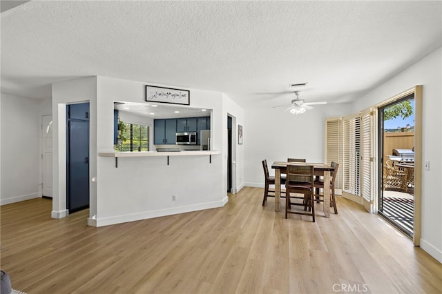 990 La Paz Rd Unit 49, Placentia, CA 92870 - dining room with light wood-style floors, a ceiling fan, and a textured ceiling