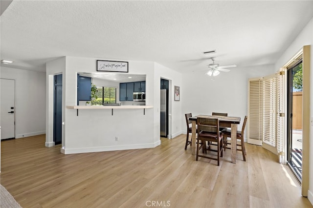 990 La Paz Rd Unit 49, Placentia, CA 92870 - dining space with healthy amount of natural light, light wood finished floors, a ceiling fan, and a textured ceiling