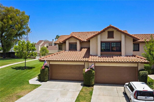 990 La Paz Rd Unit 49, Placentia, CA 92870 - mediterranean / spanish-style house featuring stucco siding, concrete driveway, a front yard, and a tile roof