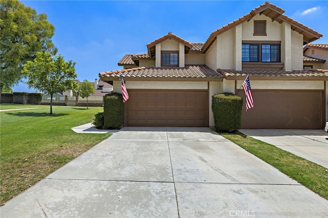 990 La Paz Rd Unit 49, Placentia, CA 92870 - view of front facade with concrete driveway, a tiled roof, a front lawn, and stucco siding
