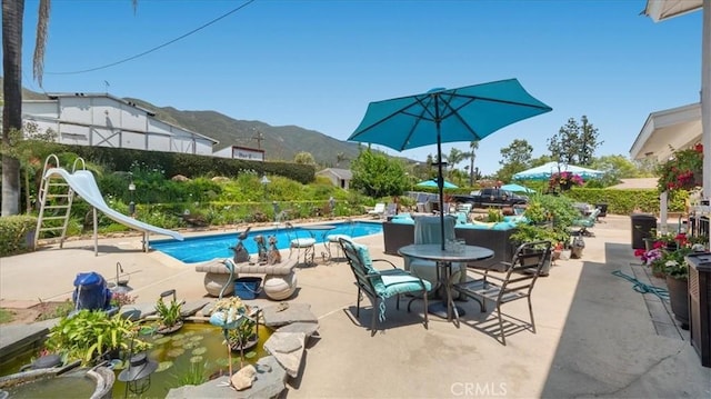 8356 Bella Vista Dr, Rancho Cucamonga, CA 91701 - swimming pool featuring a water slide, a mountain view, and a patio area
